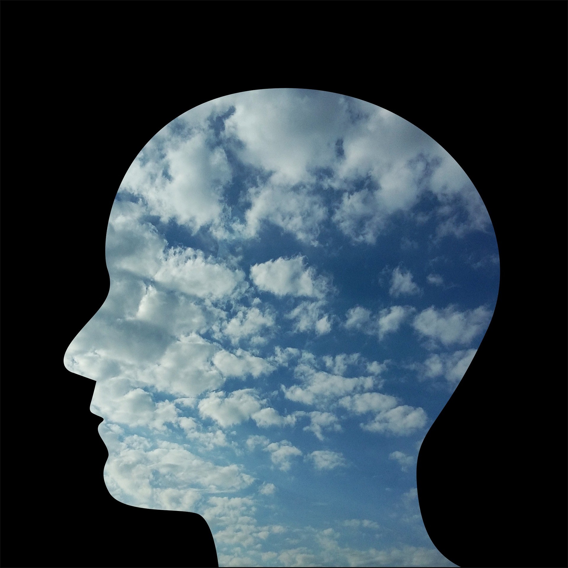 head silhouette with sky and clouds